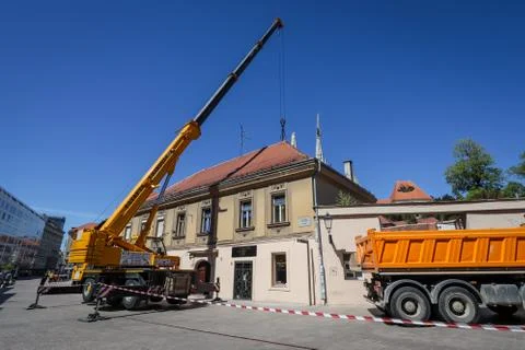 Workers with cranes fixing the roofs after earthquake Stock Photos