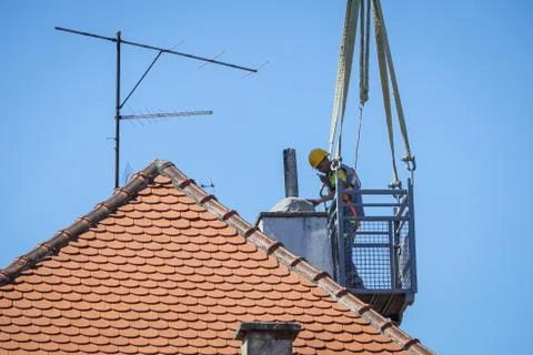 Workers with cranes fixing the roofs after earthquake Stock Photos
