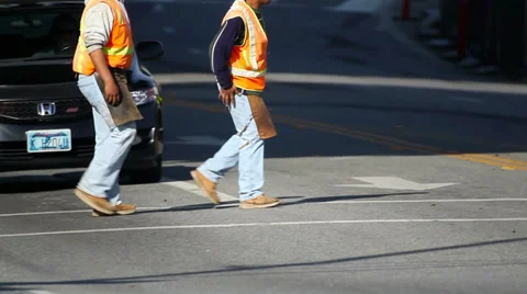Workers crossing the street moving to the construction site Stock Footage 34376650