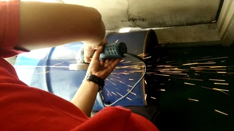 Workers cut the used barrel using the grinder Stock Footage 93012181
