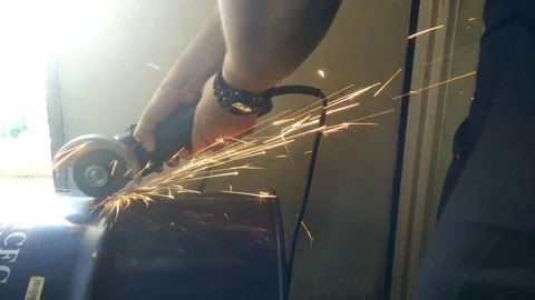 Workers cut the used barrel using the grinder Stock Footage 93012331