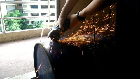 Workers cut the used barrel using the grinder Stock Footage 93012410
