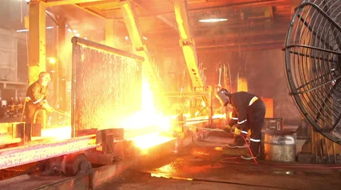Workers cutting fiery steel blocks Stock Footage