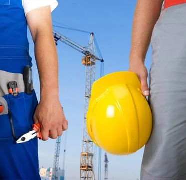 Workers Different workers man closeup on building background Copyright: xZ... Fotos de archivo