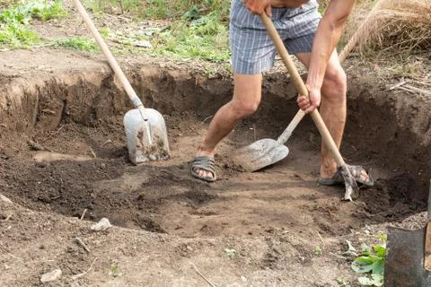Workers dig a pit for a septic tank in a private house Stock Photos