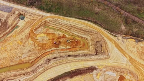 Workers dig in sand quarry during excavation process in the daytime Stock Footage 337391579
