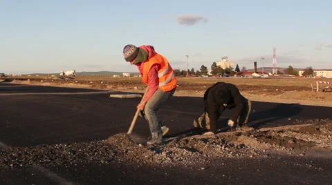 Workers dig trenches to lay cables for the airfield lighting system Stock Footage 57943670