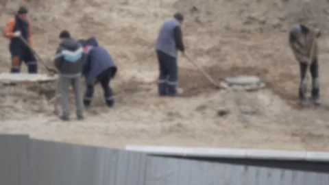Workers digging shovels at a construction site, industry. Manual labor, blurry Video stock 129935609