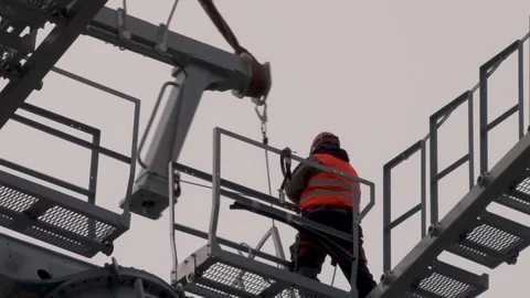 Workers direct multi-ton structure on support of cable car. Video stock 106607382
