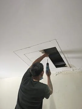 Workers dismantle the ceiling, open the ceiling Stock Photos