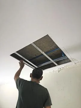 Workers dismantle the ceiling, open the ceiling Stock Photos