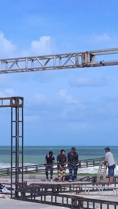 Workers dismantle stage structure after beach festival Stock Footage 333404898