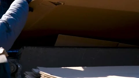 Workers dispose of the cardboard packaging for further recycling and reuse. Stock Footage 306547031