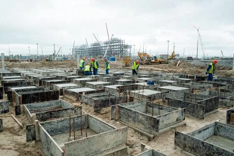 Workers do base under big oil tank Stock Photos