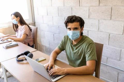 Workers doing office work on computers with social distance Stock Photos