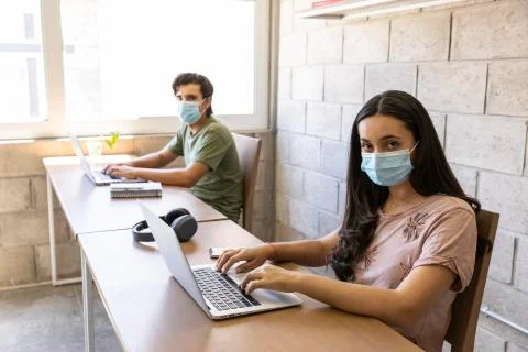 Workers doing office work on computers with social distance Stock Photos