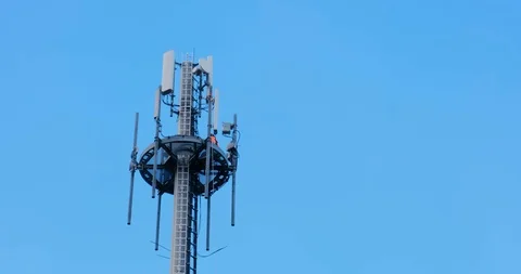 Workers doing repairs on a telecommunication tower pan from left to right Stock Footage 125186268