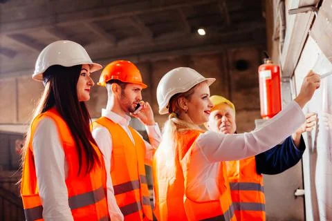 The workers draw up a plan of work at the plant Stock Photos