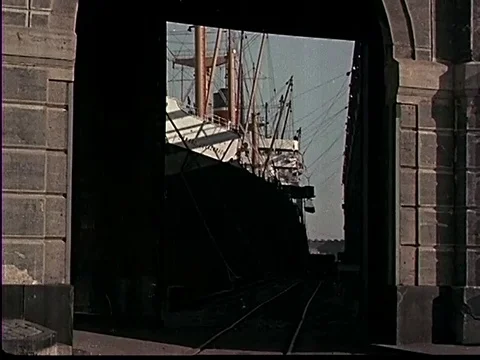 Workers drive forklifts, move large pipes, cranes lift cargo - 1953 Stock Footage 107363291
