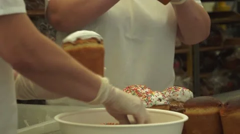 Workers Easter cupcake sprinkled with colorful sweet powder Stock Footage 68386500