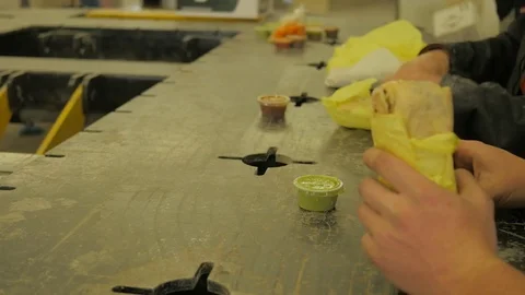 Workers eating burritos at break time. Video stock 74265169