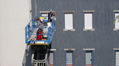 Workers on the elevator restoring building Stock Footage 49376542