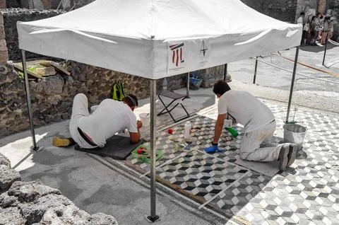 Workers engaged in the restoration work of ancient Roman mosaics in Pompei,.. Stock Photos