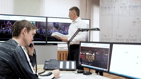 Workers of engineering department in electrical power plant working in office. Stock Footage 114500985