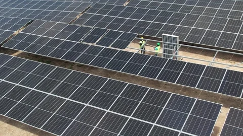 Workers with equipment maintaining solar panels, aerial view Stock Footage 278367993