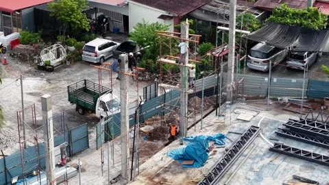 Workers erect steel frames on a bustling construction site Stock Footage 338996323