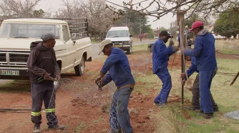 Workers erecting a fence Stock Footage 59913647