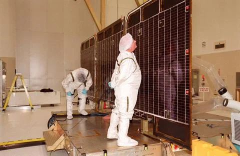 Workers examine parts of the opened solar array panels on the 2001 Mars Od... Stock Photos