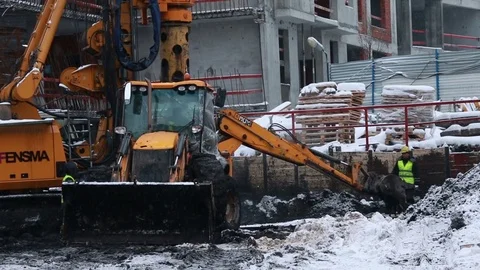 Workers, excavator and pile rig machine at construction site. Stock Footage 71533353