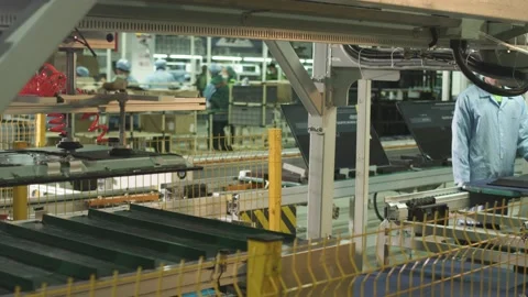 Workers on a factory assembly line for the production of home televisions Stock Footage 162365745