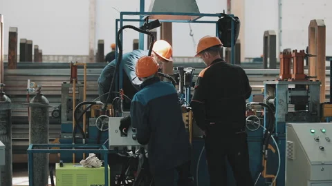 Workers in the factory at the machine Stock Footage 157507615