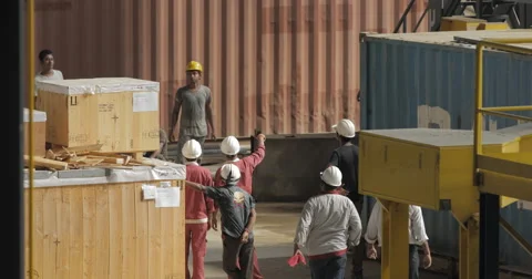 Workers in a Factory Workshop Directing Movement Of Cargo (4K) Stock Footage 60771726