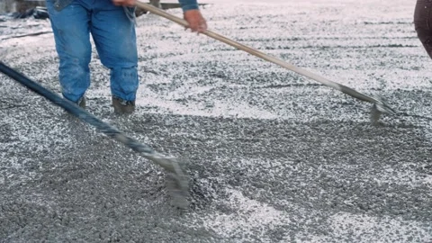 Workers fill the foundation of the building with cement. Filling concentrate for Stock Footage 200792851