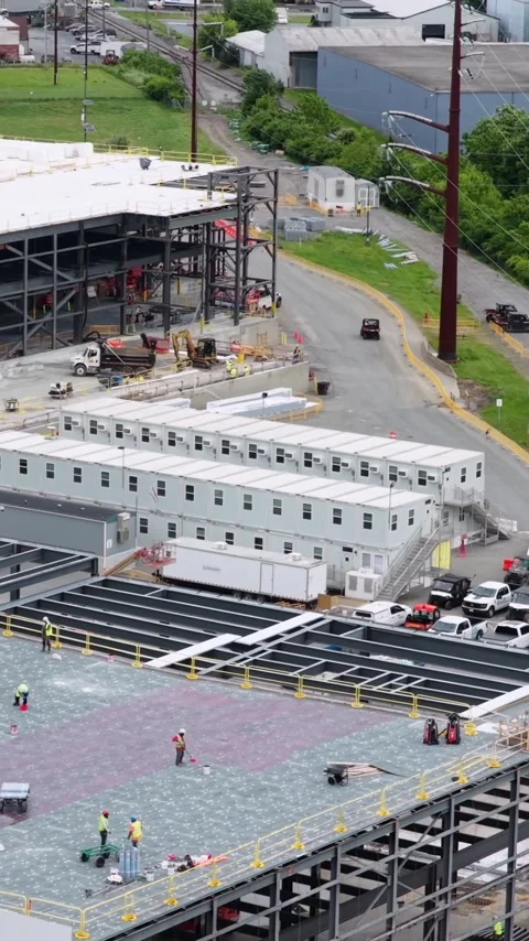 Workers finish a roof deck at a data center construction site in Lancaster Stock Footage 345727993