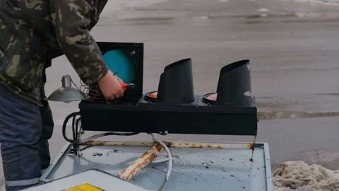 Workers fix the lights of a broken traffic light Stock Footage 168496062