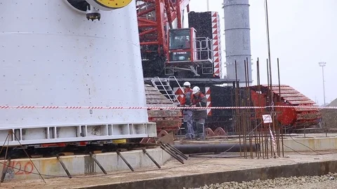 Workers Fix Metal Tower Bottom behind Protective Tape Stock Footage