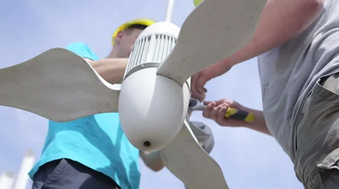 Workers fix small wind turbine Stock Footage 64669865