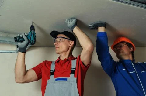 Workers fixes the drywall Stock Photos