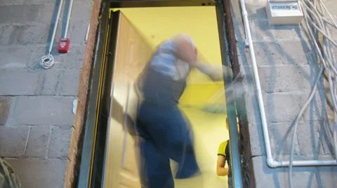 Workers fixing the door in the wall frame Stock Footage 28540188