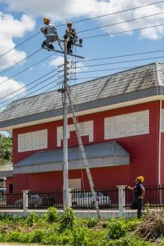 Workers fixing electrical lines Stock Photos
