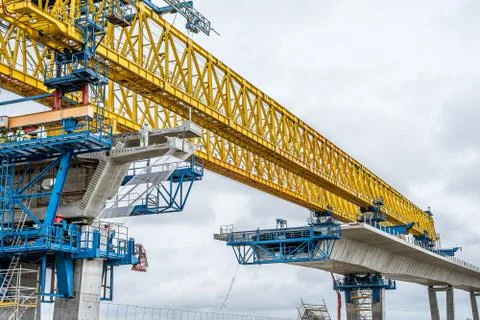 Workers fixing elements of concrete  when building a bridge Stockfoto's