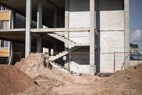 Workers focus on constructing a multi-story building framed with concrete. Sa Stock Photos