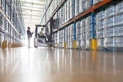 Workers with forklift in bottling warehouse Stock Photos
