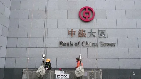 Workers get ready to fix and clean the facade of the Chinese state-owned Stock Footage 171821294
