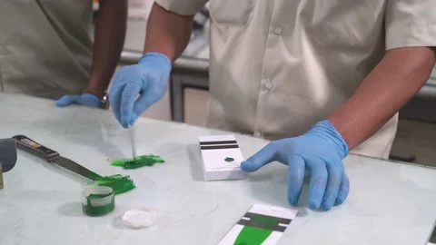 Workers with gloves doing green paint sample test at a factory Stock Footage 234143581