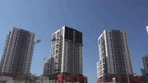 Workers glueing bricks outside of tower Stock Footage 106769720